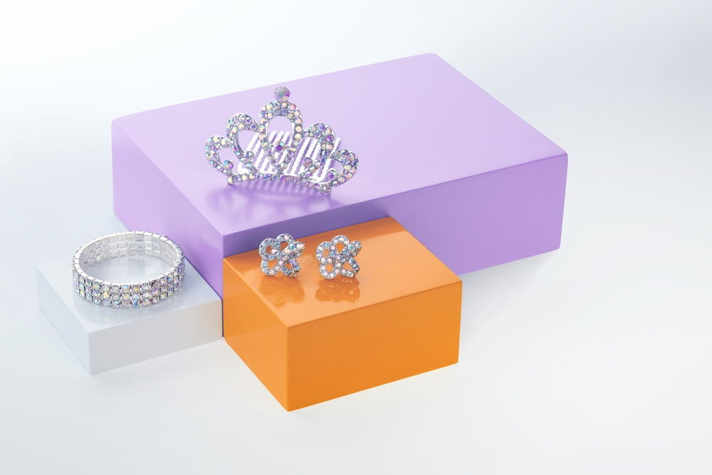 A pair of 18mm AB crystal stud earrings with a floral design, displayed on a purple platform with a solid metal closure backing, intended for pierced ears.